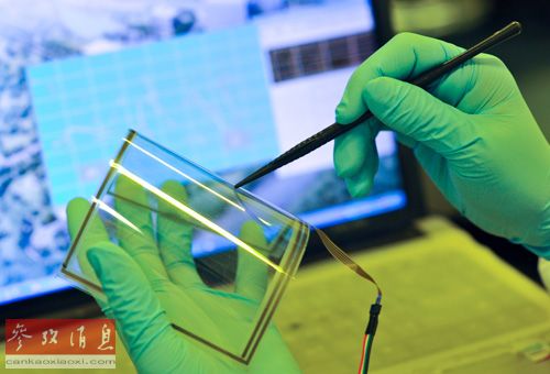 資料圖片：2013年1月24日，中科院重慶綠色智能技術(shù)研究院的一名研究人員在彎曲的單層石墨烯觸摸屏上進(jìn)行書寫功能測(cè)試。新華社記者 劉潺 攝